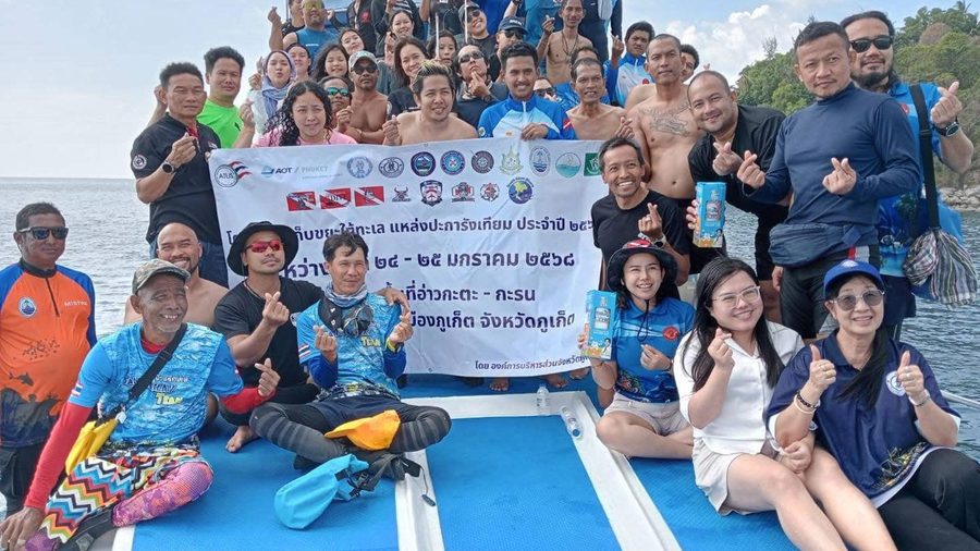 Super Dive Thailand cleanup group gathered on a boat after conservation work
