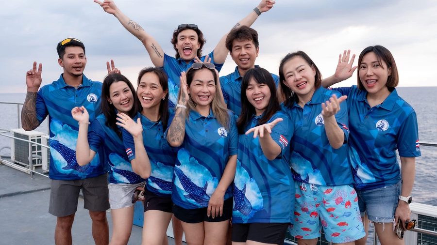 Super Dive Thailand team and guests smiling together on a boat deck