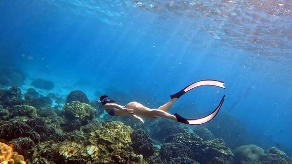 Freediver training in clear blue water