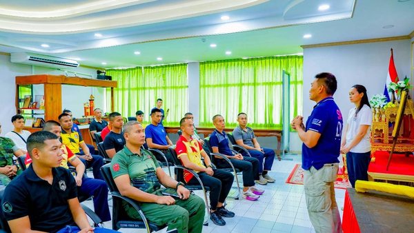 Instructor briefing water-safety trainees in a classroom