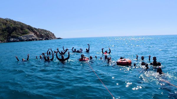 Water-safety training group practicing in open water