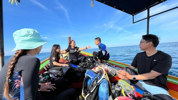 Dive briefing on a boat with students and equipment prepared