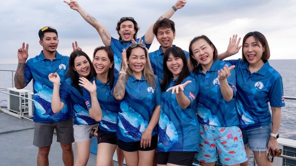 Super Dive Thailand team smiling together on a boat deck