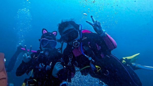 Two divers posing together underwater during a supervised dive